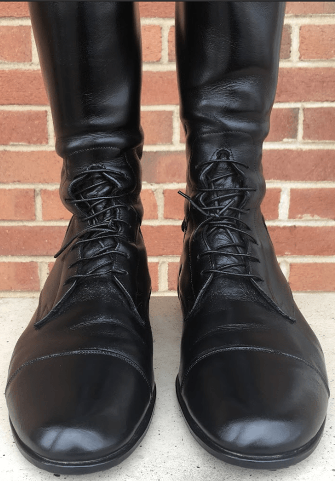 The same black lace-up boots after cleaning and polishing