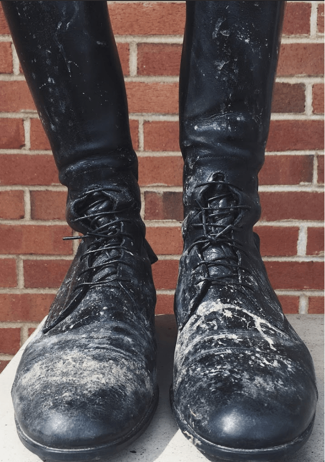 Black lace-up boots before cleaning